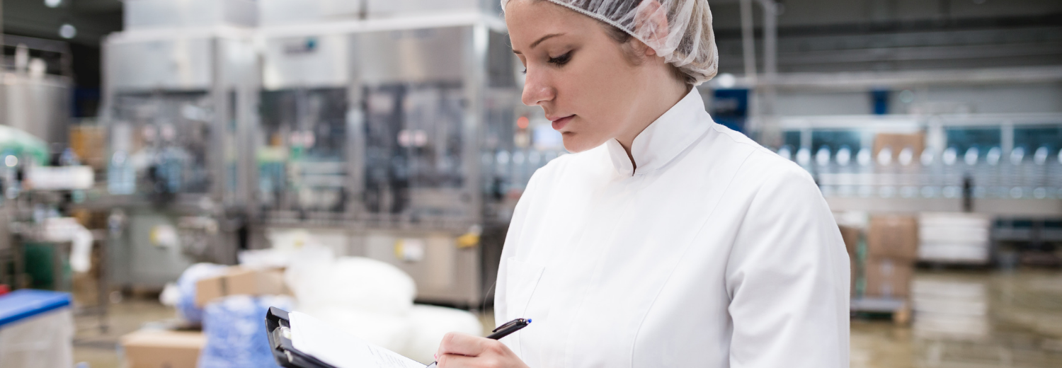 Factory with woman going through a checklist